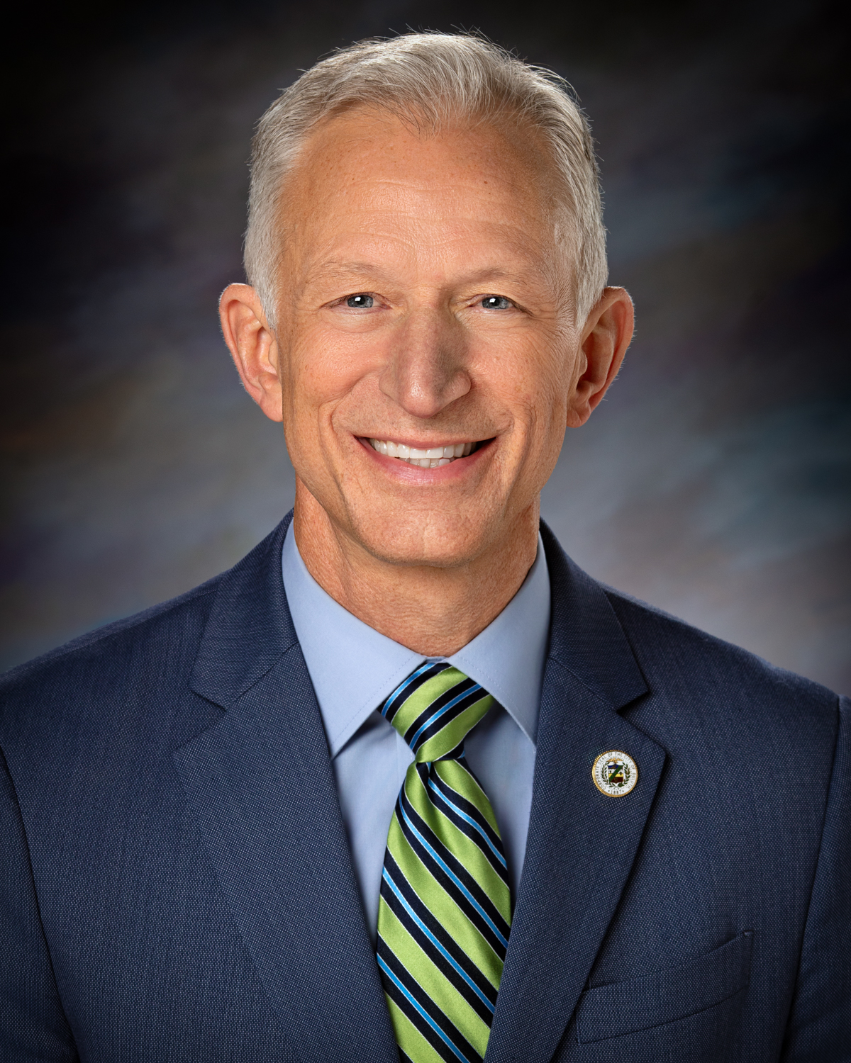 Reinert Roger Formal Headshot With Seal